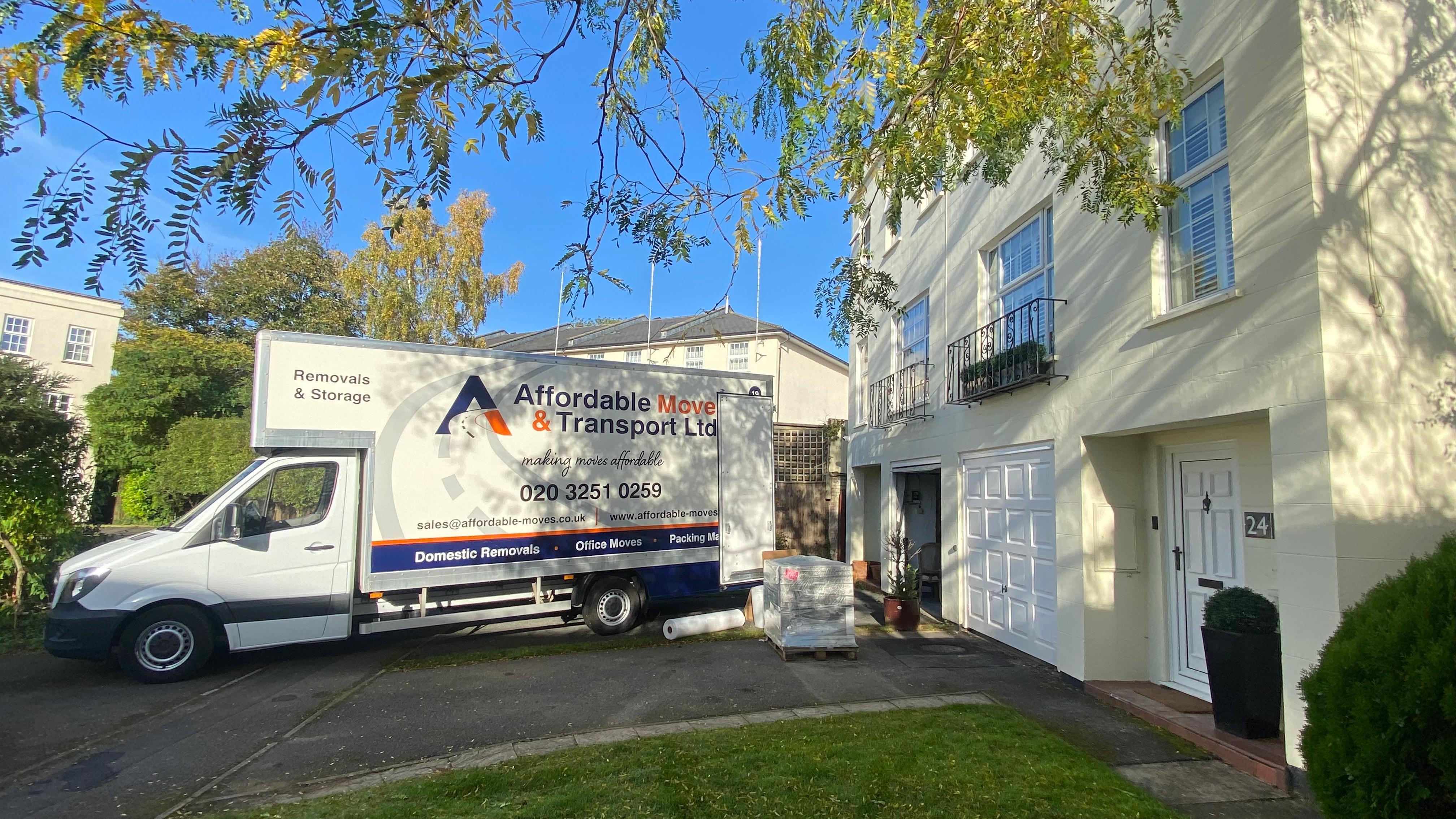 Professional house removals team loading furniture into van
